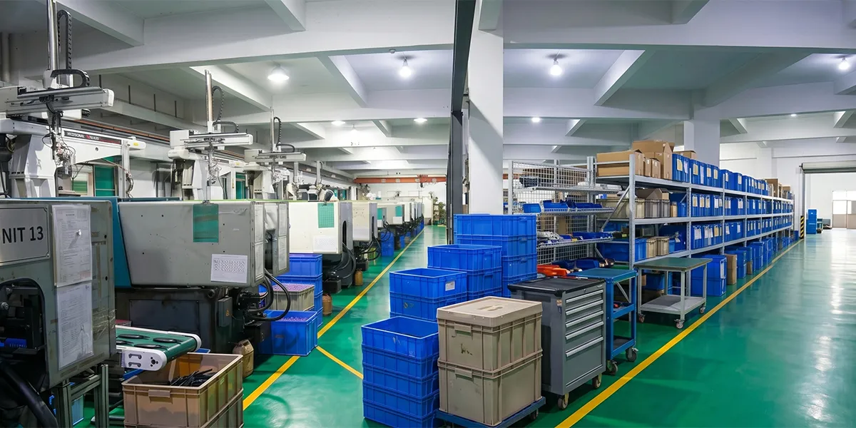 Interior of a hair clip factory showing an acetate production line with CNC cutting machines and polishing workstations
