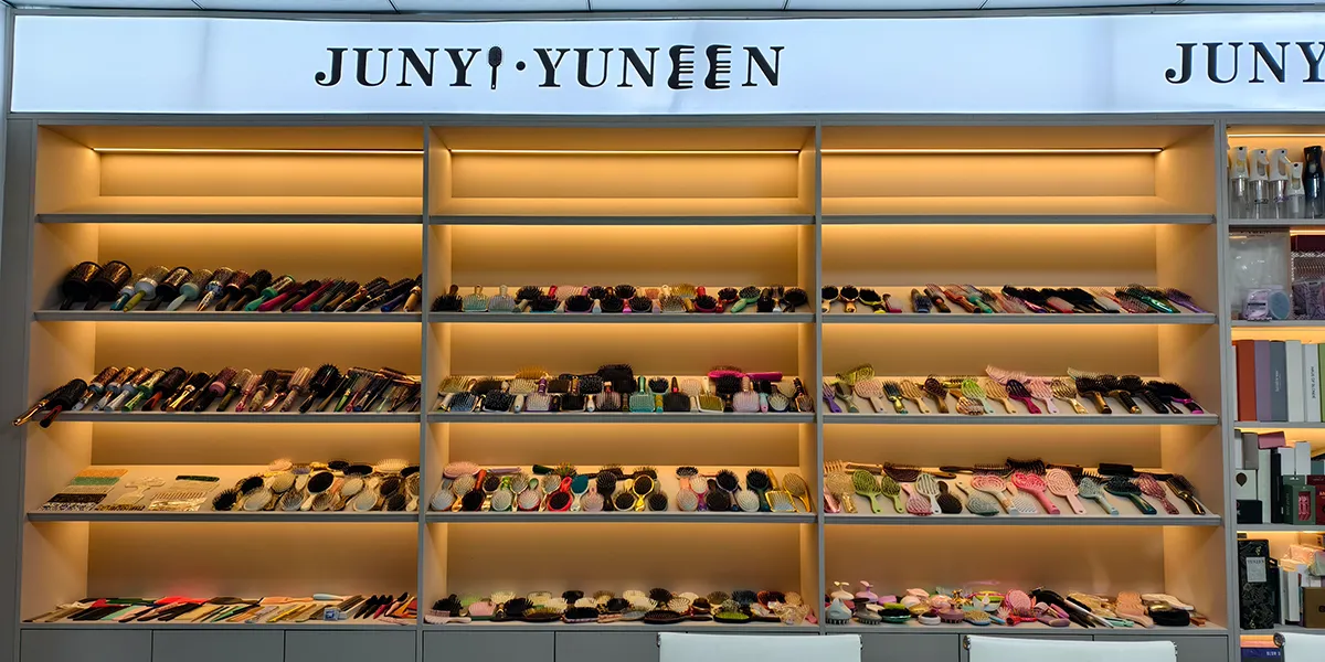 Hair clip manufacturer showroom with acetate and plastic clip samples displayed on glass shelves for buyer review