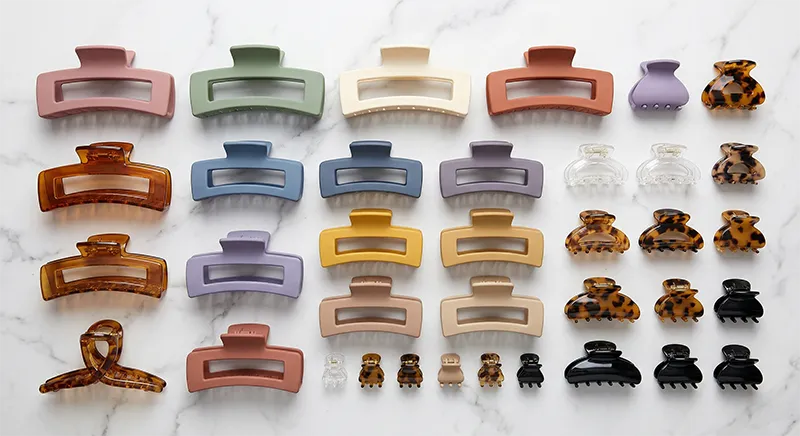 Assorted claw clips in multiple sizes and colours arranged in a flat lay for retail display