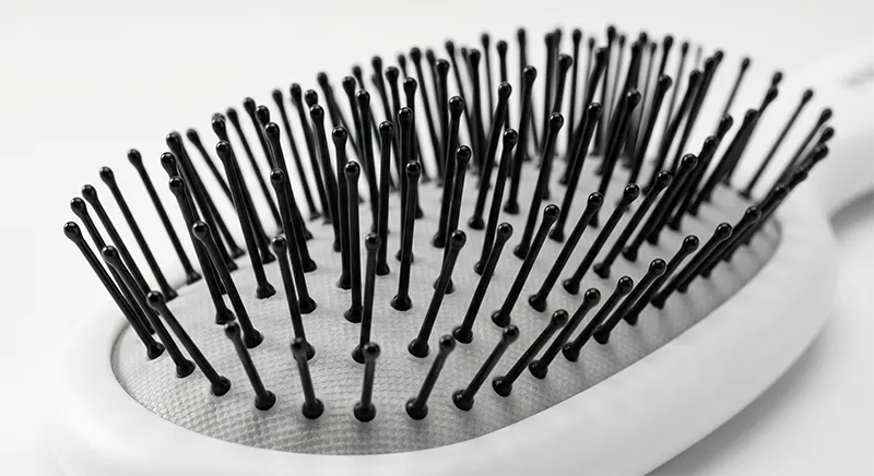 Hair sectioned into panels for controlled detangling, showing end-to-root working direction