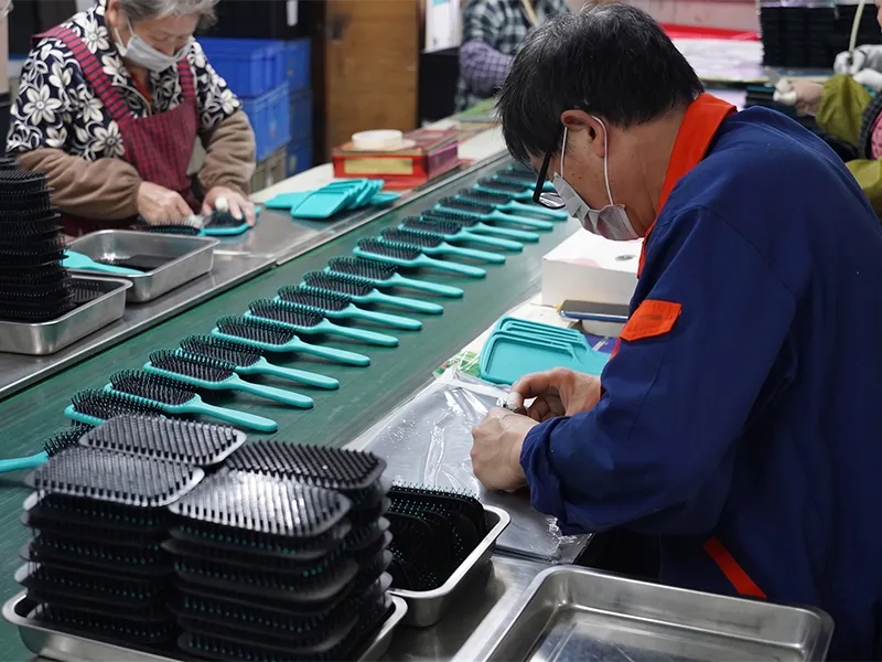 Hairbrush assembly line with workers