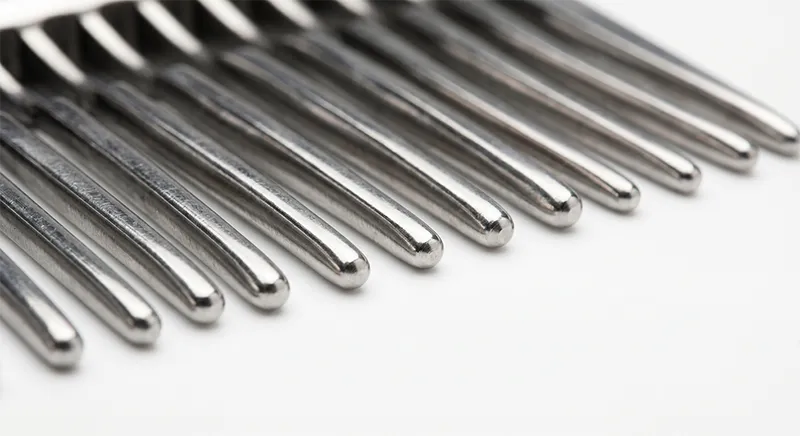 Close-up of stainless steel comb teeth showing smooth polished tips and uniform spacing