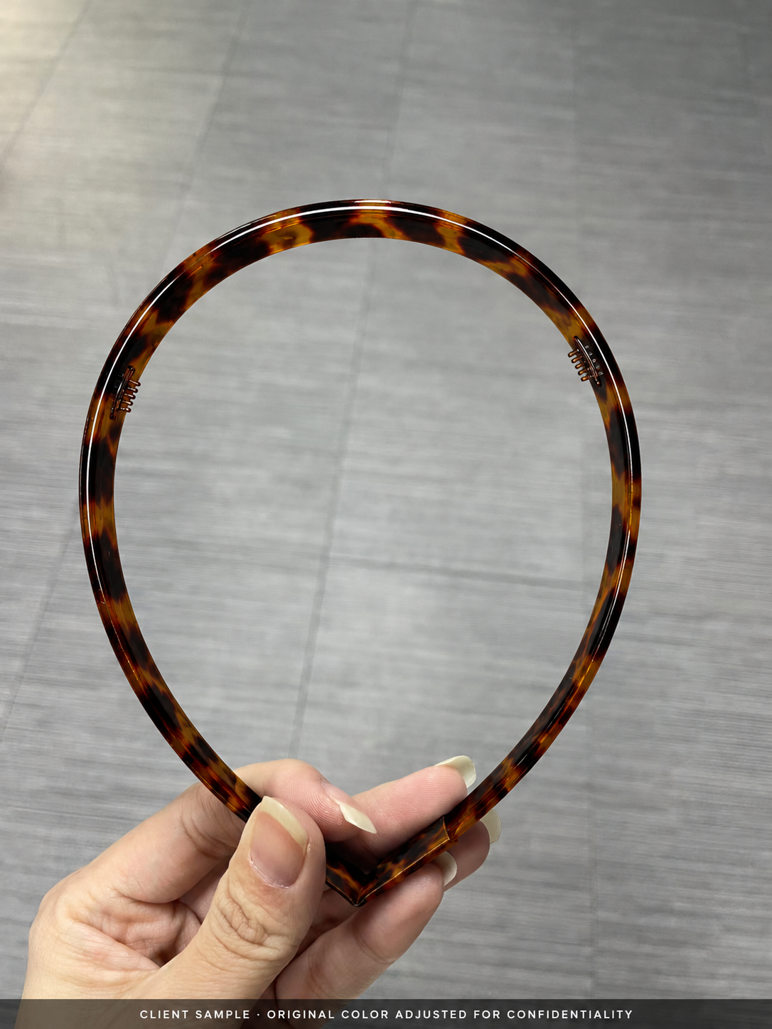 An anonymised tortoiseshell headband sample used to review width, tooth layout and fit