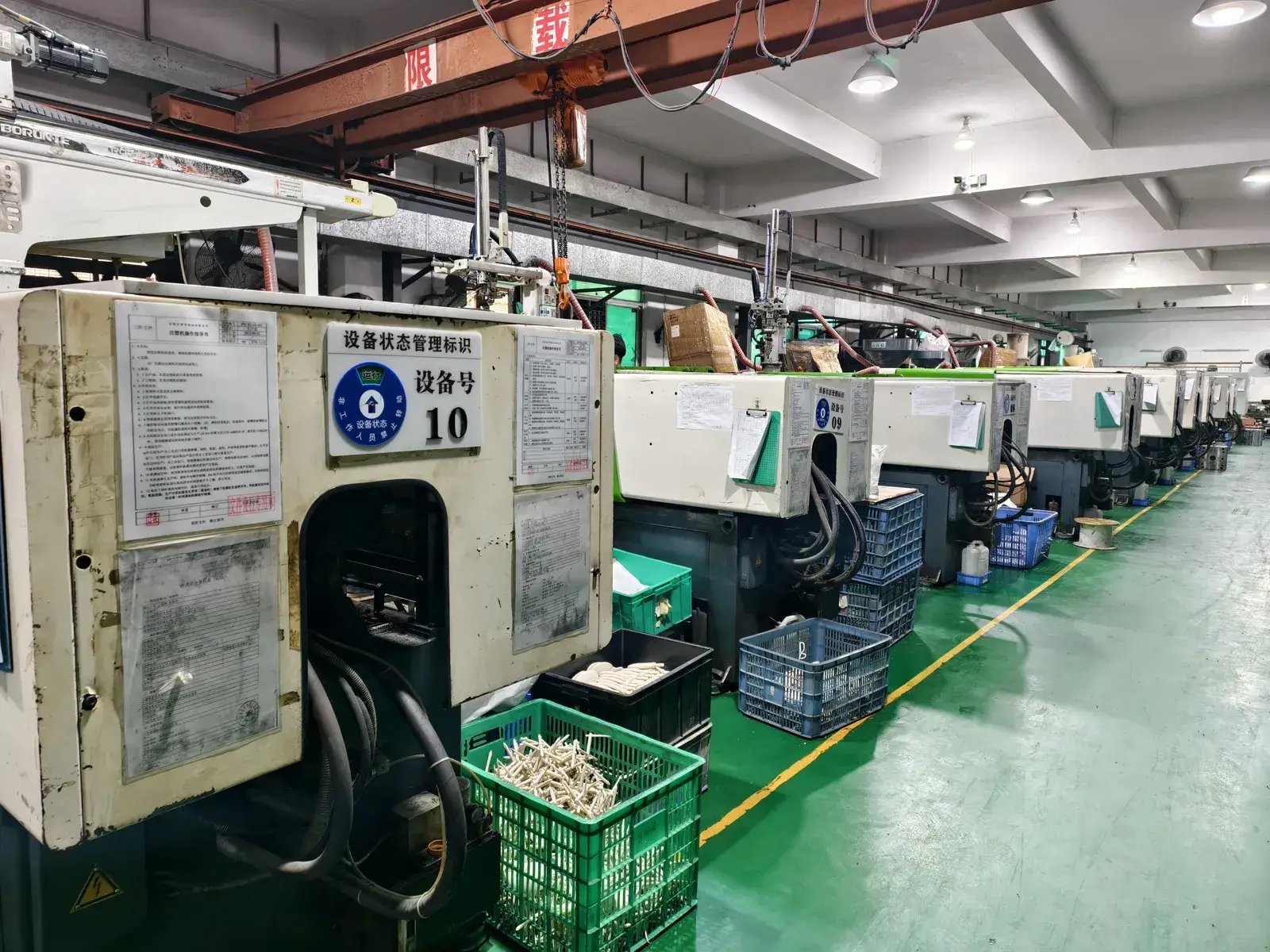 Row of injection moulding machines producing hair brush and comb parts at the production base